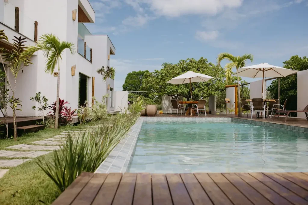 Beautiful modern villa with a pool surrounded by lush greenery in Bahia, Brazil.